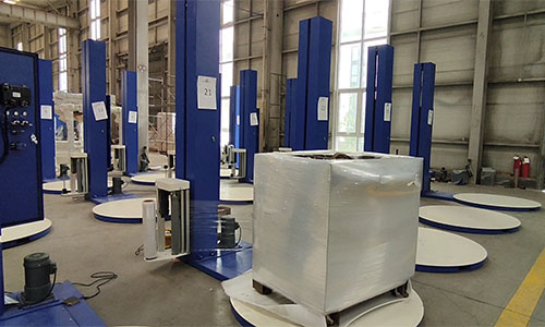 What are the advantages of using a stretch wrapping machine, and how does it compare to manual packaging?